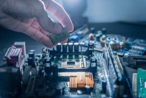 stock photo of person placing chip in board